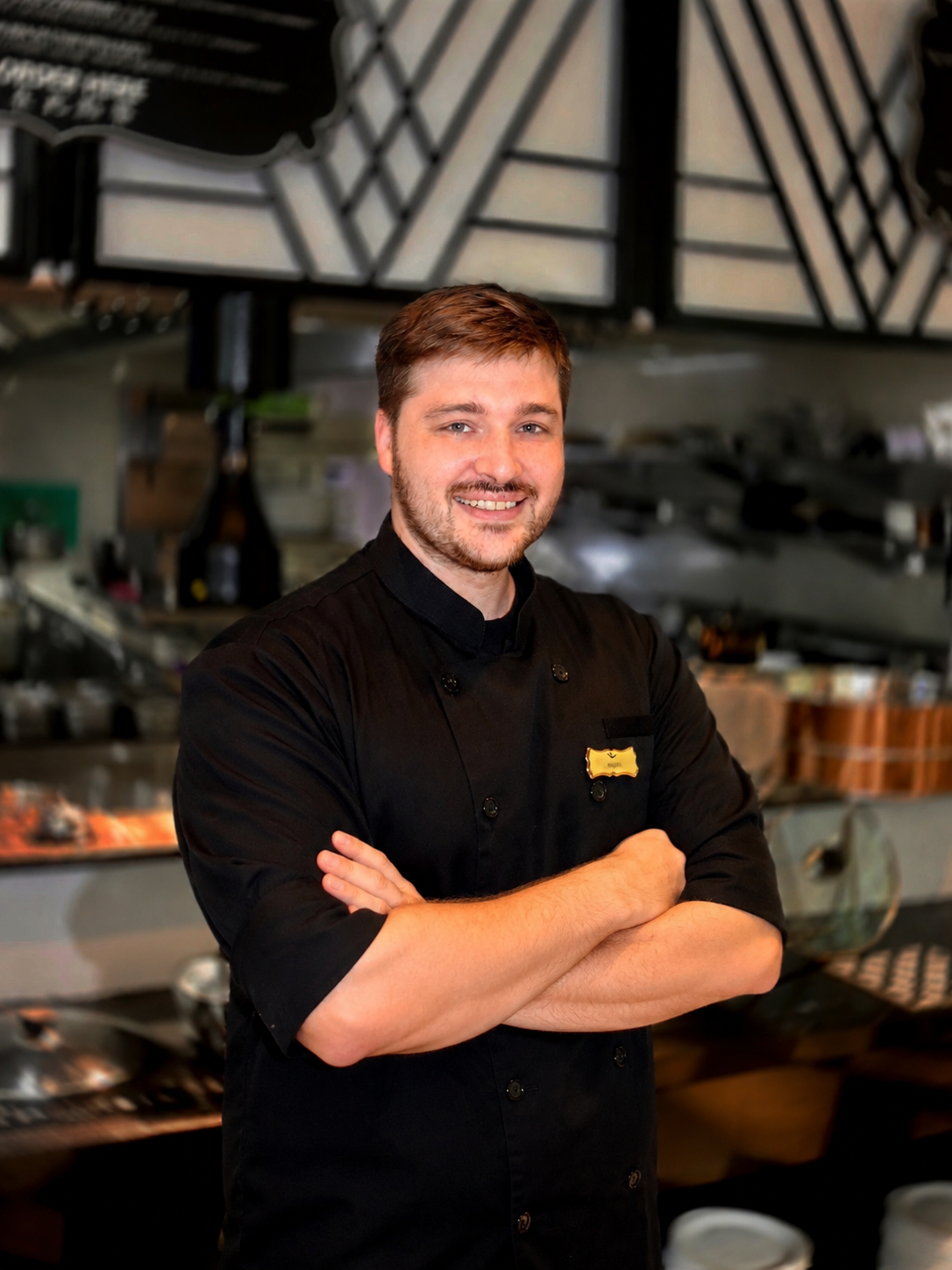 Chef Hugo smiling in the kitchen at Atrio Restaurant